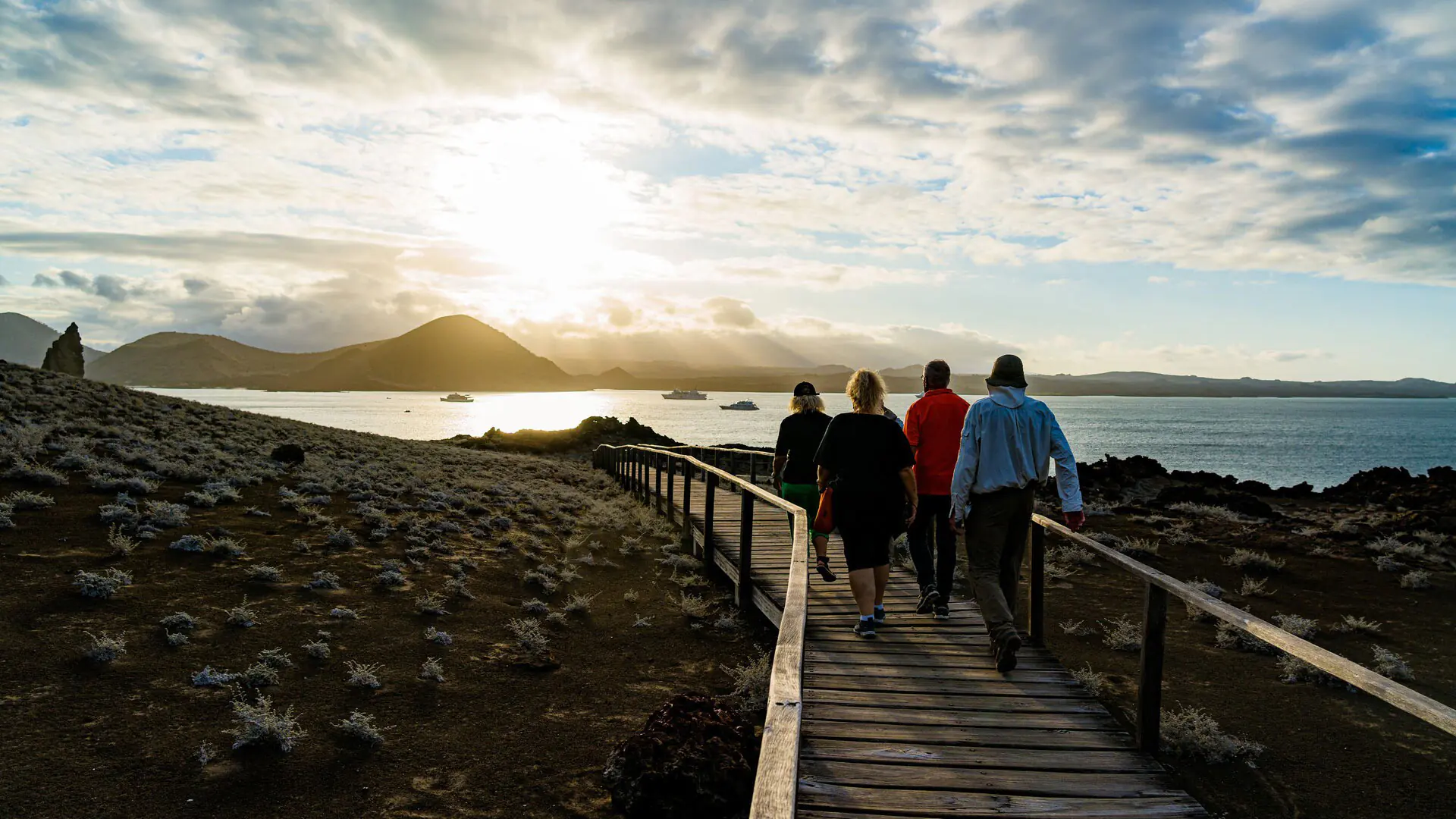 Travelers walking at bartolone island in galapagos