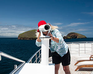 tourist admiring the galapagos islands from a cruise