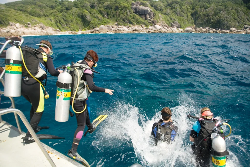 scuba divers exploring tropical waters off boat at Galapagos Island diving